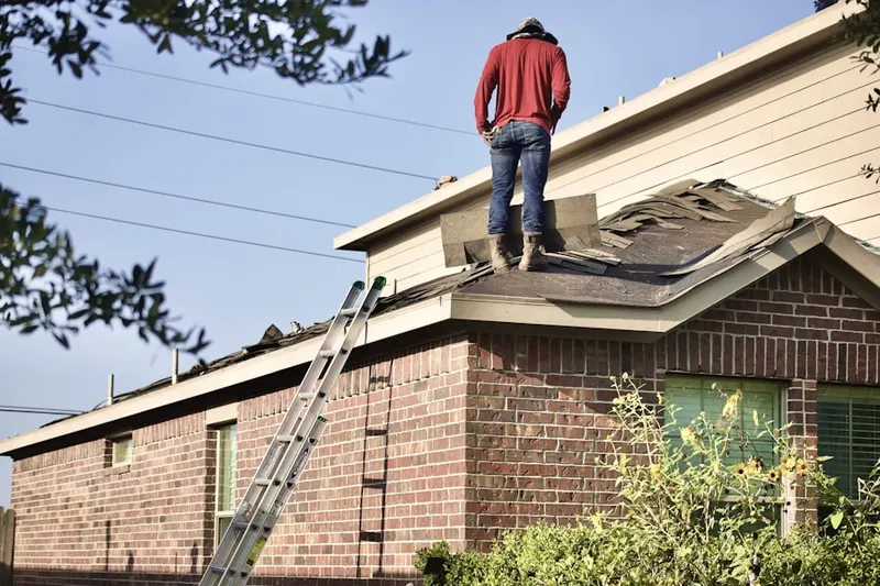 Professional roofer working on a residential roof in Escalon